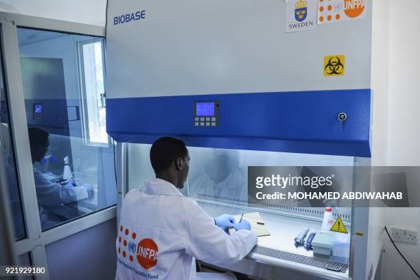 Photo taken on January 24 shows the laboratory technicial officer Mohamed Ali Abdi demonstrating DNA testing at the Puntland Forensic Center in...
