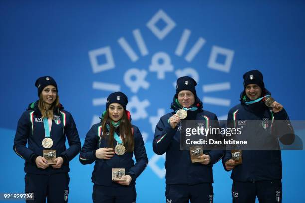 Bronze medalists Lisa Vittozzi, Dorothea Wierer, Lukas Hofer and Dominik Windisch of Italy celebrate during the medal ceremony for the Biathlon 2x6km...