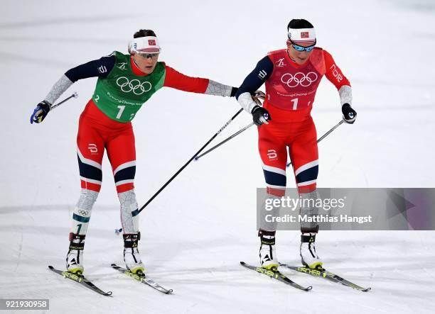 Marit Bjoergen of Norway and Maiken Caspersen Falla of Norway handover during the Cross Country Ladies' Team Sprint Free Final on day 12 of the...