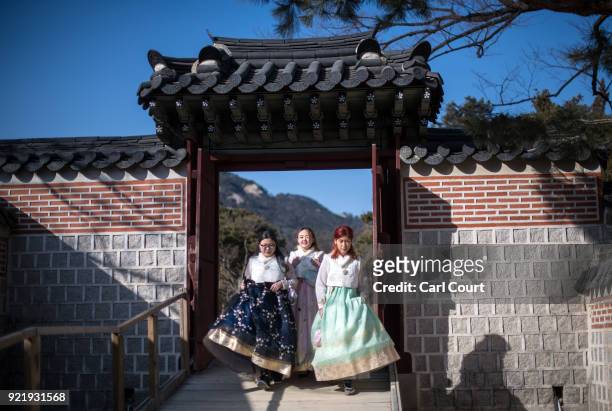 Tourists wearing traditional Korean Hanbok dresses visit Gyeongbokgung Palace on February 21, 2018 in Seoul, South Korea. With tourists visiting from...
