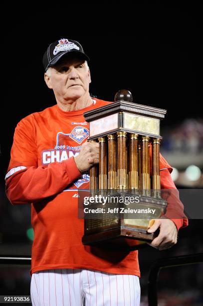 Manager Charlie Manuel of the Philadelphia Phillies hold the trophy as he celebrates defeating the Los Angeles Dodgers 10-4 to advance to the World...