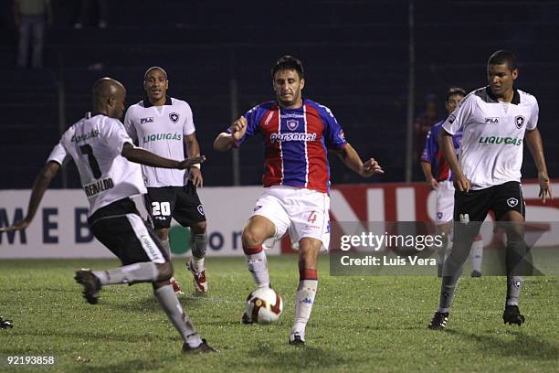 Brazil's Botafogo Reinaldo and Wellington fight for the ball with Paraguay's Cerro Porteno Diego Herner during their match as part of the 2009 Copa...