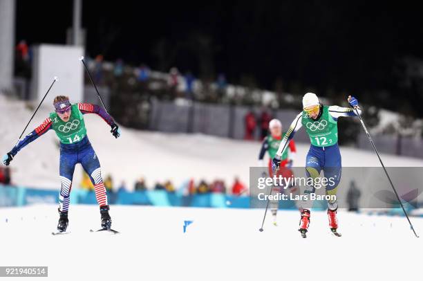 Jessica Diggins of the United States stretches across the finish line to win gold ahead of Stina Nilsson of Sweden during the Cross Country Ladies'...