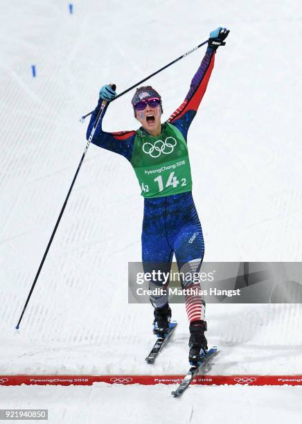 Jessica Diggins of the United States stretches across the finish line to win gold during the Cross Country Ladies' Team Sprint Free Final on day 12...