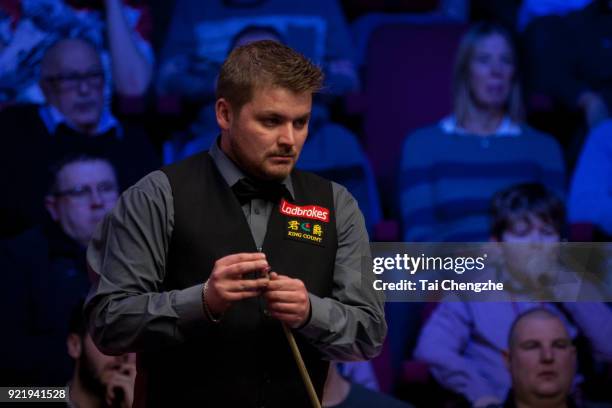 Michael White of Wales chalks the cue during his first round match against Judd Trump of England on day two of 2018 Ladbrokes World Grand Prix at...