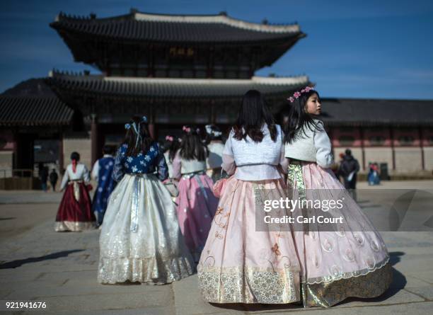 Tourists wearing traditional Korean Hanbok dresses visit Gyeongbokgung Palace on February 21, 2018 in Seoul, South Korea. With tourists visiting from...