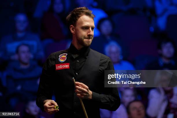 Judd Trump of England chalks the cue during his first round match against Michael White of Wales on day two of 2018 Ladbrokes World Grand Prix at...