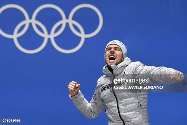 Germany's gold medallist Johannes Rydzek poses on the podium during the medal ceremony for the nordic combined Individual Gundersen LH/10km at the...