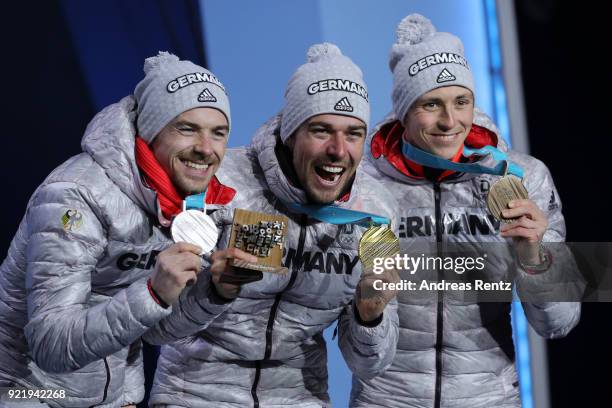 Silver medalist Fabian Riessle of Germany, gold medalist Johannes Rydzek of Germany and bronze medalist Eric Frenzel of Germany celebrate during the...