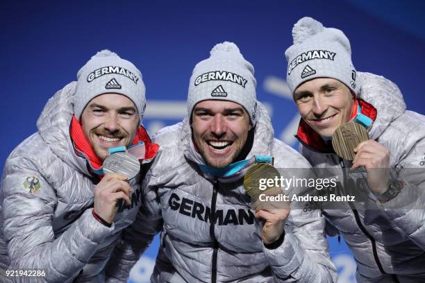 Silver medalist Fabian Riessle of Germany, gold medalist Johannes Rydzek of Germany and bronze medalist Eric Frenzel of Germany celebrate during the...