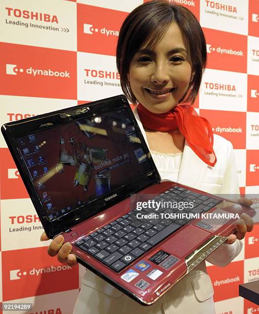Model of Toshiba shows off the company's new laptop PC, "dynabook MX" during the company's Microsoft Windows 7 PC press preview in Tokyo on October...