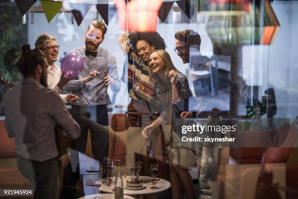 large group of happy entrepreneurs dancing during office party. - office party stock pictures, royalty-free photos & images