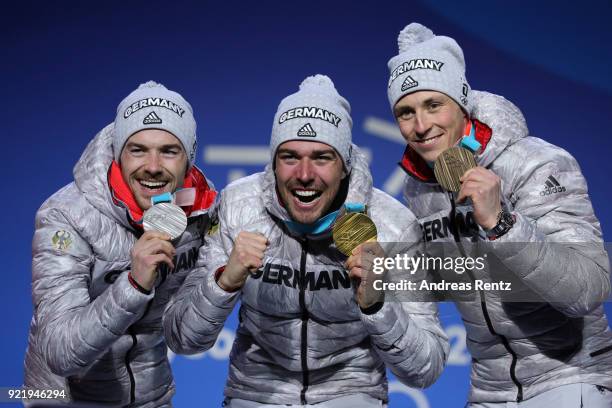 Silver medalist Fabian Riessle of Germany, gold medalist Johannes Rydzek of Germany and bronze medalist Eric Frenzel of Germany celebrate during the...