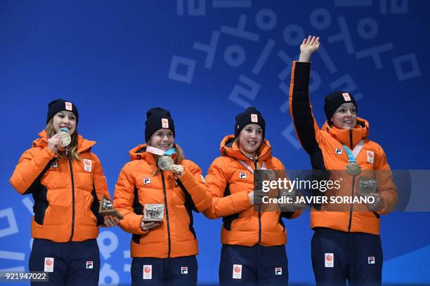 Netherlands' bronze medallists Suzanne Schulting, Yara van Kerkhof, Lara van Ruijven and Jorien ter Mors pose on the podium during the medal ceremony...