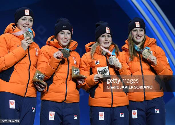 Netherlands' bronze medallists Suzanne Schulting, Yara van Kerkhof, Lara van Ruijven and Jorien ter Mors pose on the podium during the medal ceremony...