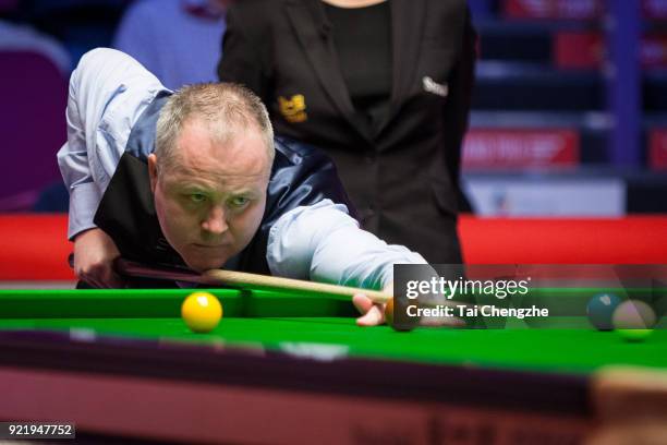 John Higgins of Scotland plays a shot during his first round match against Ali Carter of England on day two of 2018 Ladbrokes World Grand Prix at...