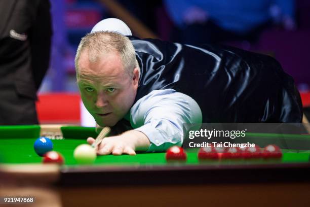 John Higgins of Scotland plays a shot during his first round match against Ali Carter of England on day two of 2018 Ladbrokes World Grand Prix at...