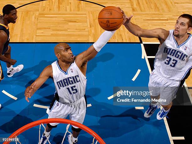Orlando Magic guard Vince Carter grabs a rebound as team mate forward Ryan Anderson looks on during a pre-season game against the Indiana Pacers on...