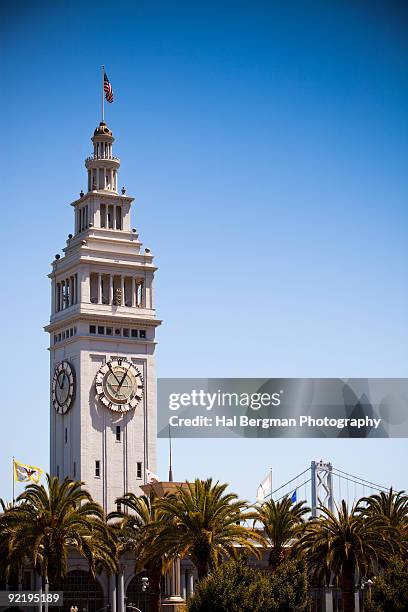 san francisco ferry building and the bay bridge - turmuhr stock-fotos und bilder