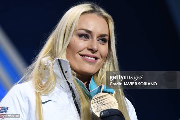 S bronze medallist Lindsey Vonn poses on the podium during the medal ceremony for the alpine skiing Women's Downhill at the Pyeongchang Medals Plaza...