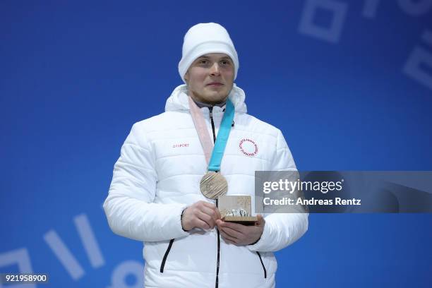 Bronze medalist Sergey Ridzik of Olympic athletes of Russia celebrates during the medal ceremony for the Freestyle Skiing Men's Ski Cross Big Final...