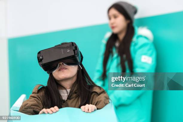 Visitor wears a virtual reality headset as she tries a virtual bobsleigh in the PyeongChang 2018 Winter Olympics Live Site on February 21, 2018 in...