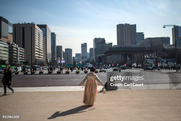 Women wearing a traditional Korean Hanbok dress poses for a photograph near Gyeongbokgung Palace on February 21, 2018 in Seoul, South Korea. With...