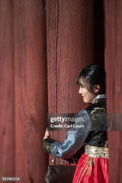 Woman wearing a traditional Korean Hanbok dress poses for a photograph as she visits Gyeongbokgung Palace on February 21, 2018 in Seoul, South Korea....