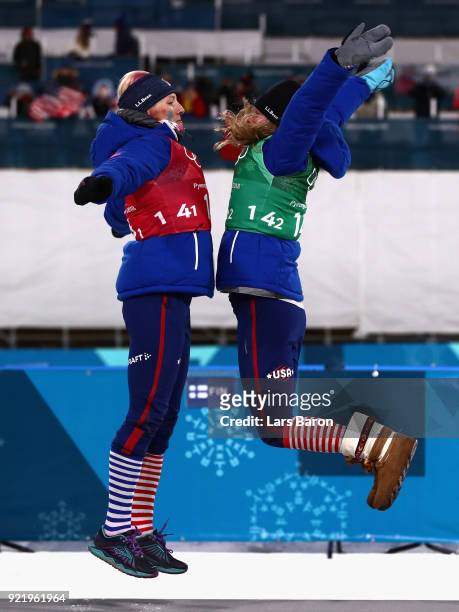 Kikkan Randall of the United States and Jessica Diggins of the United States celebrate on the podium during the victory ceremony for the Cross...