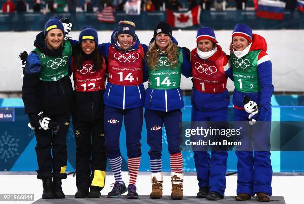 Silver medalists Stina Nilsson and Charlotte Kalla of Sweden, gold medalists Kikkan Randall and Jessica Diggins of the United States and bronze...