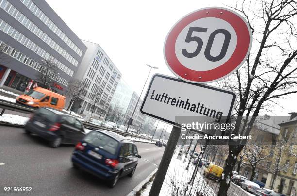 Cars drive along Landshuter Allee, one of the streets in Germany with the highest measured levels of nitrogen oxides, next to a traffic sign that...