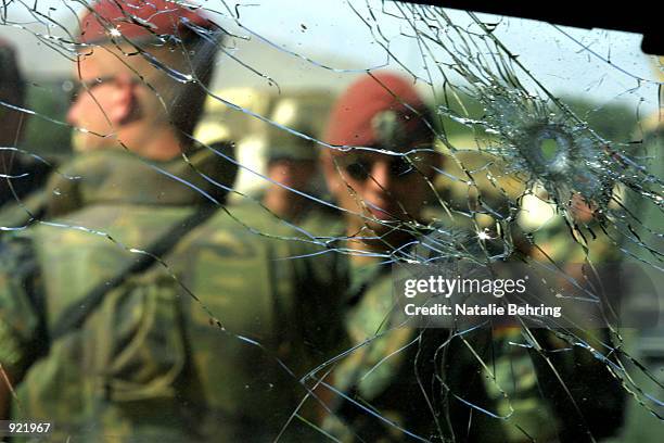 German peacekeepers guard a car in which Afghan Vice President Haji Abdul Qadir was assassinated as he drove into his office compound July 6, 2002 in...