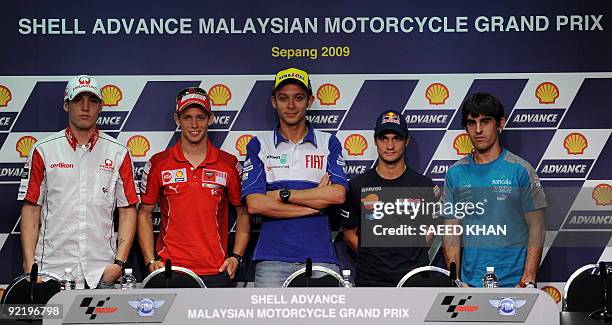 World Champion motorcycle rider Valentino Rossi of Italy posses for photographs along with Aleix Espargaro of Spain, Casey Stoner of Australia,...