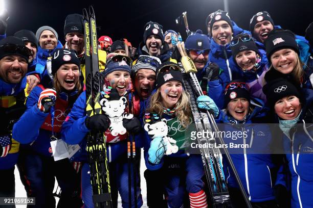 Gold medalists Kikkan Randall of the United States and Jessica Diggins of the United States celebrate with coaches and team mates after the Cross...