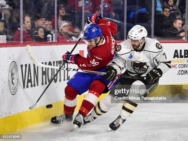 Jordan Boucher of the Laval Rocket and Connor Hobbs of the Hershey Bears chase the puck along the boards during the AHL game at Place Bell on...