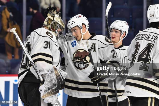 Aaron Ness of the Hershey Bears congratulates goaltender Vitek Vanecek for their victory against the Laval Rocket during the AHL game at Place Bell...