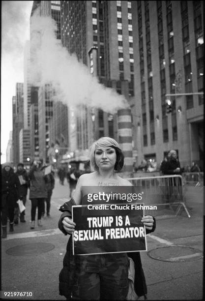 View of an unidentified demonstrator on Sixth Avenue during the Women's March on New York, New York, New York, January 20, 2018. She holds a sign...