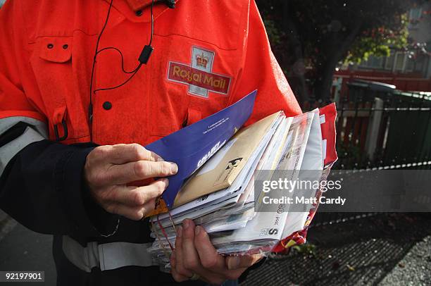 Postman Gerry Cryer delivers the post on October 23, 2009 in Bristol, England. Although some postal workers were on strike today, domestic deliveries...