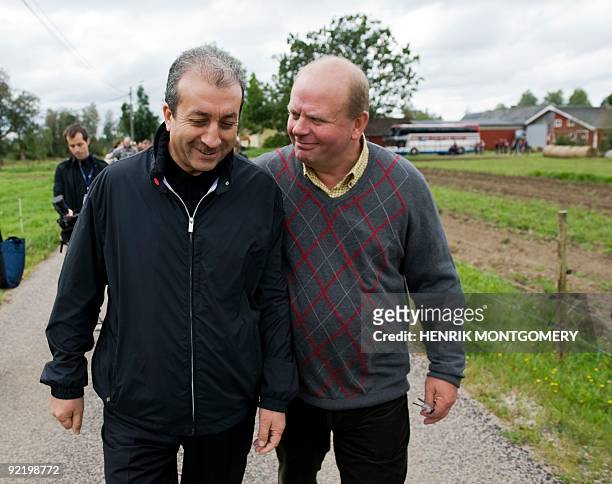 Portugal's Agriculture Minister Jaime Silva and Swedish counterpart Eskil Erlandsson chat during a visit to an agriculture farm near Vaxjo, Sweden,...