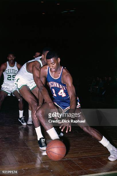 Oscar Robertson of the Cincinnati Royals drives to the basket against the Boston Celtics during a game played in 1964 at the Boston Garden in Boston,...