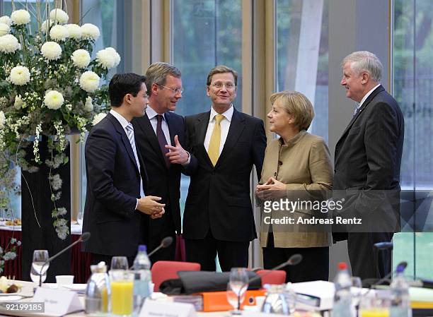 Philipp Roesler of the German Free Democrats , Lower Saxony Governor Christian Wulff, Guido Westerwelle, leader of the FDP, German Chancellor and...