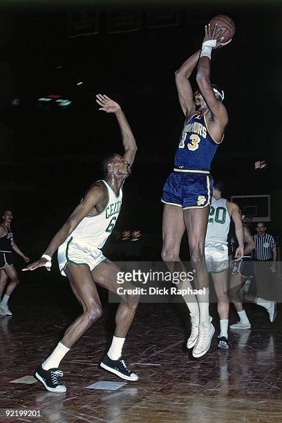 Wilt Chamberlain of the San Francisco Warriors shoots a jumper against Bill Russell of the Boston Celtics during a game played in 1964 at the Boston...