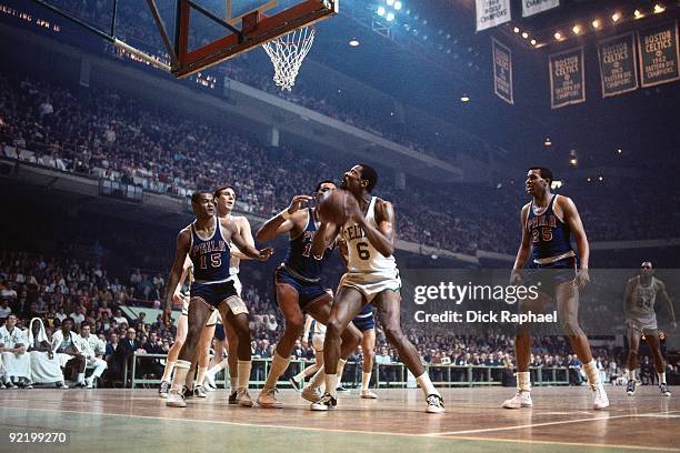 Bill Russell of the Boston Celtics makes a move to the basket against Wilt Chamberlain, Hal Greer and Chet Walker of the Philadelphia 76ers during a...