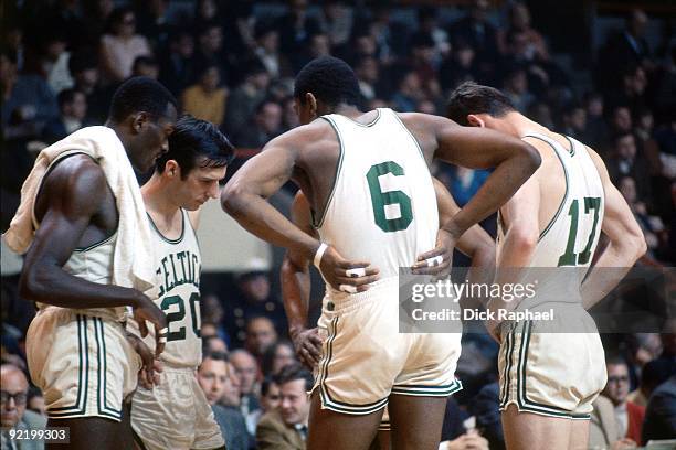 Larry Seigfried, Satch Sanders, Bill Russell and John Havlicek of the Boston Celtics huddle up during a game played in 1968 at the Boston Garden in...