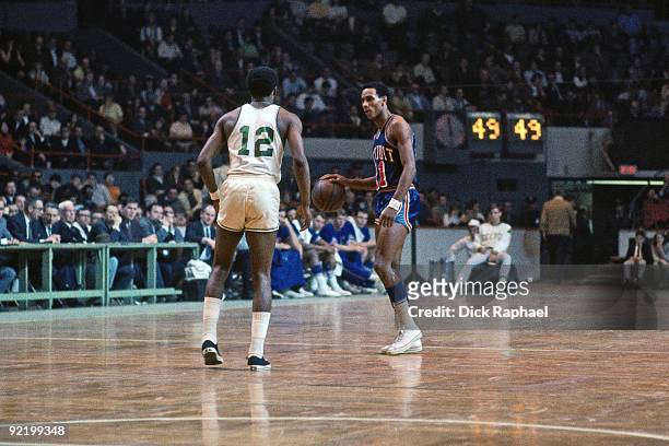 Dave Bing of the Detroit Pistons moves the ball against Don Chaney of the Boston Celtics during a game played in 1968 at the Boston Garden in Boston,...