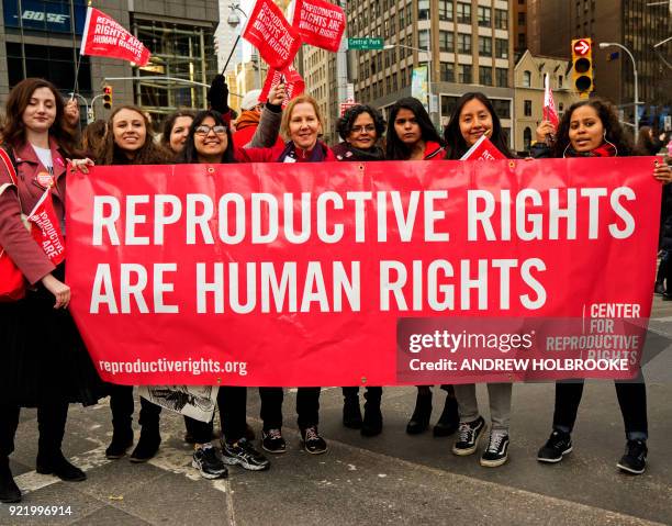 Members of the Center for Reproductive Rights holds a banner saying, "Reproductive Rights Are Human Rights," One year after the inauguration of...