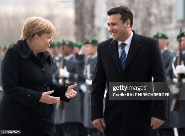 German Chancellor Angela Merkel and Macedonian Prime Minister Zoran Zaev review an honour guard in the courtyard of the Chancellery prior to their...