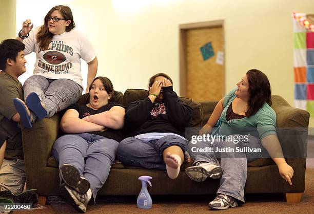 Mary Healy, Makayla Smith, Marissa Hamilton and Elizabeth Fedorchalk react as a classmate surprises them as they sit in the girls dorm at Wellspring...