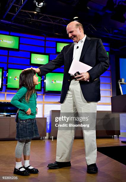 Steven Ballmer, chief executive officer of Microsoft Corp., right, talks with Kylie, a girl who has appeard in Microsoft's "I'm a PC" television...