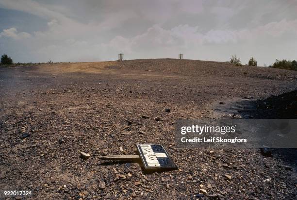 View of an uprooted 'No Trespassing' sign on the ground in Centralia, Pennsylvania, July 1992. The town was largely abandoned due to an underground...